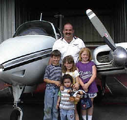 photo of volunteer pilot and plane with children he transported